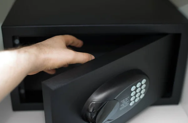 Man's hand opening small safe. — Stock Photo, Image