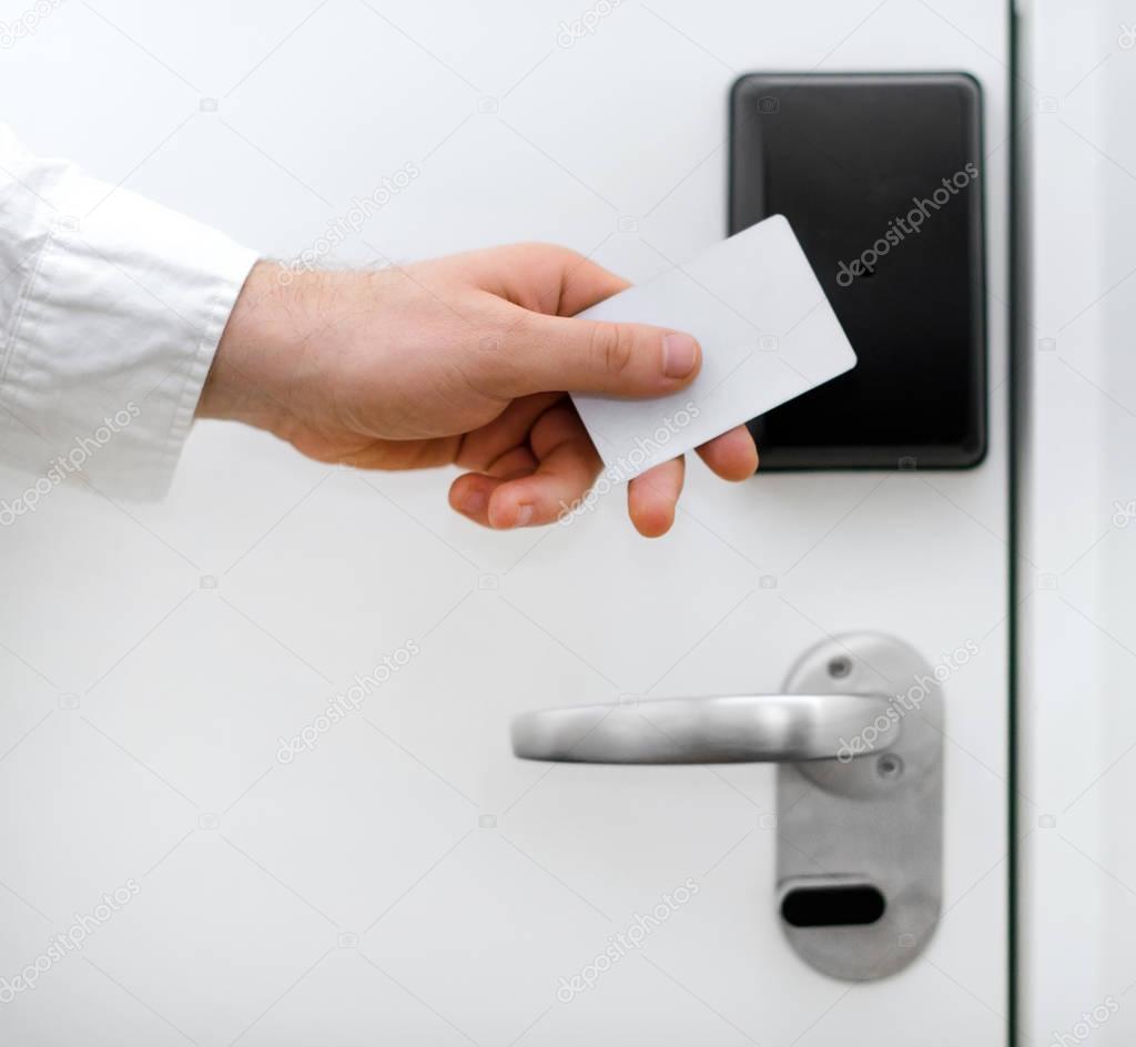 Man using contactless key in the hotel.