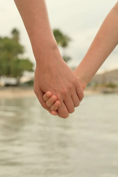 Mother holding hand of her daughter. — Stock Photo, Image