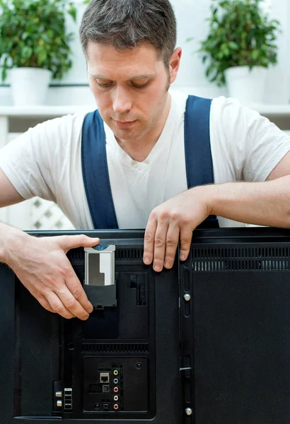 Man installing conditional access module card to TV. — Stock Photo, Image