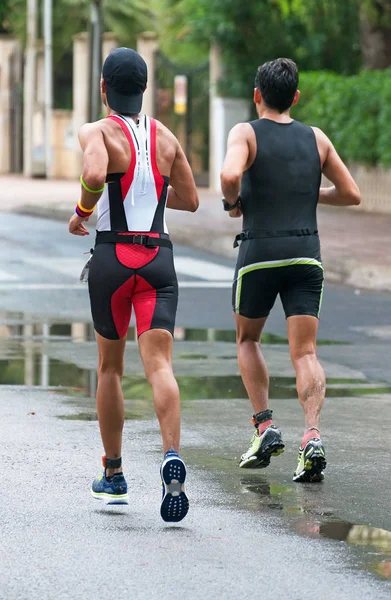 Male runners on the city road. Back view. — Stock Photo, Image