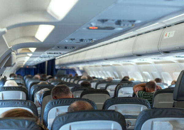 Interior inside of the plane with passengers.