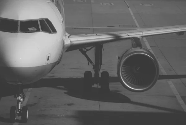 Close-up view of airplane on airfield in airport. Black and white. — Stock Photo, Image