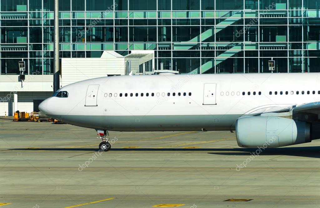 Side View of airplane on airfield in airport.