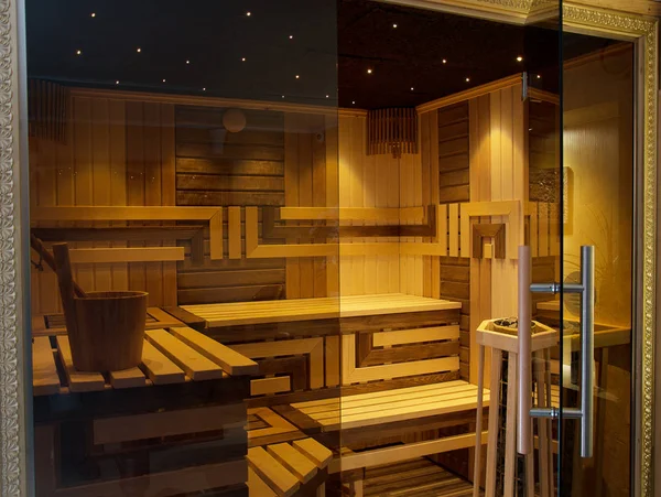 Interior of Finnish Sauna behind glass door.