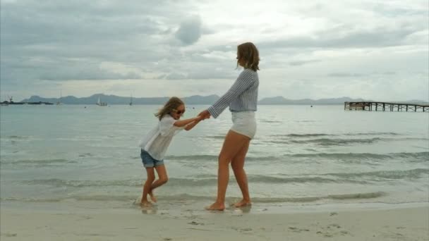 Frau und ihre Tochter amüsieren sich im Meer. — Stockvideo