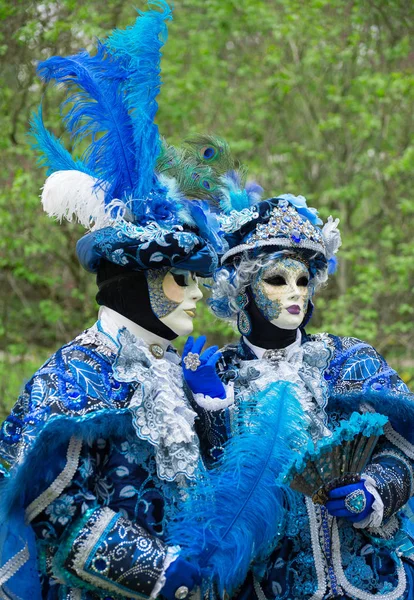 Unrecognizable people in venetian masks on street carnival. — Stock Photo, Image