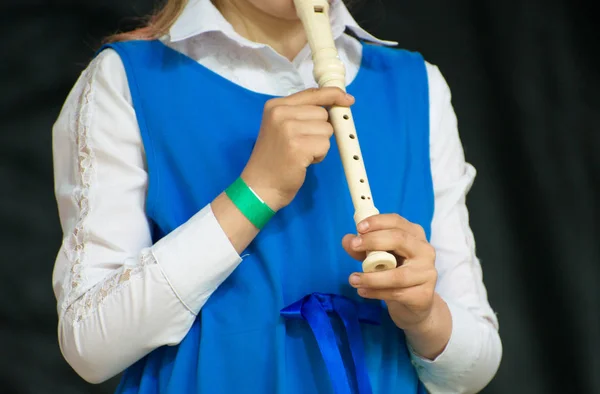 Girl with flute performing on stage. — Stock Photo, Image