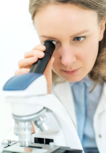 Scientist using microscope in laboratory. Royalty Free Stock Photos