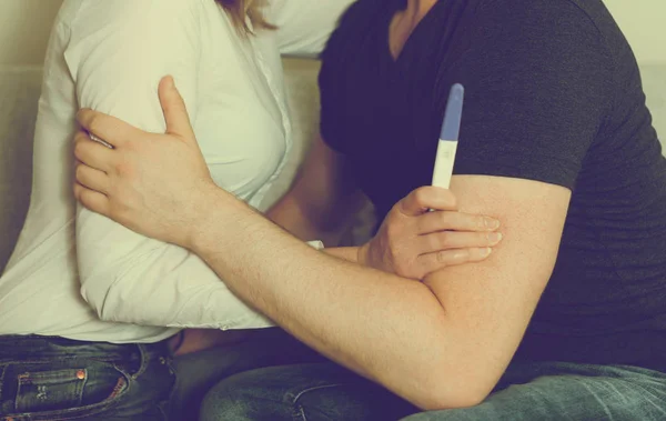 Girl with pregnancy test hugging her boyfriend. — Stock Photo, Image