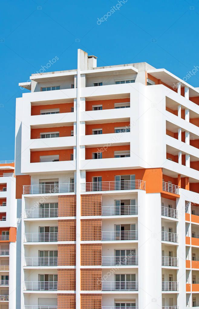 Orange apartment building in Portimao city, Portugal.