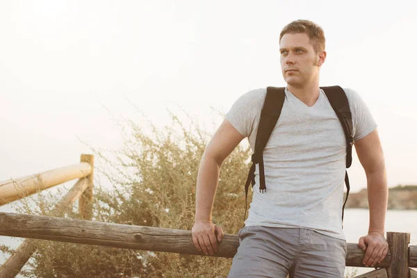 Handsome male tourist with backpack. Space for text. — Stock Photo, Image