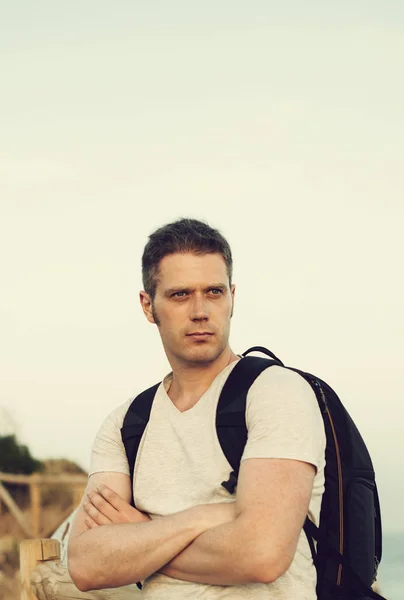 Handsome male tourist with backpack. Space for text. — Stock Photo, Image
