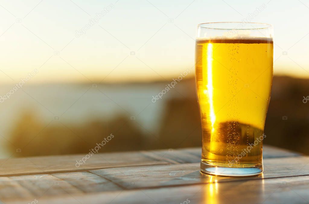 Glass of beer on the sunset.