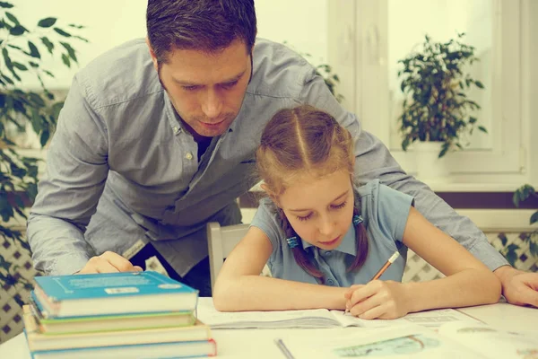 Vader dochter helpen met huiswerk thuis. — Stockfoto