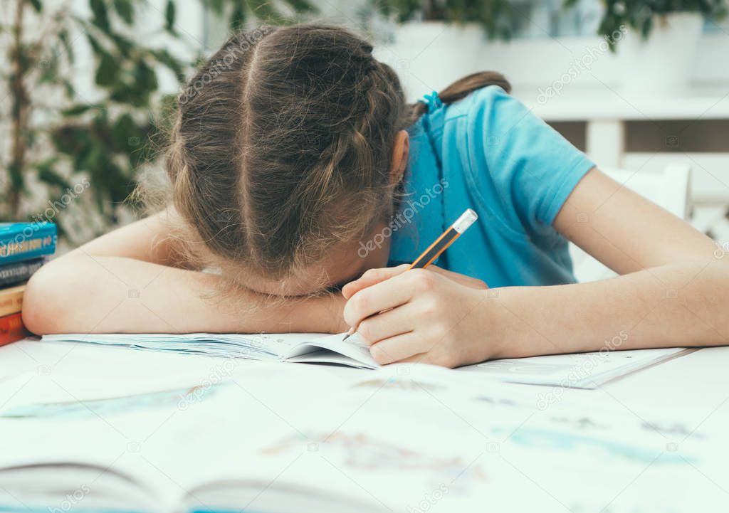 Little girl don't want to do her homework.