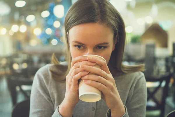 Mujer está bebiendo café en la cafetería . — Foto de Stock