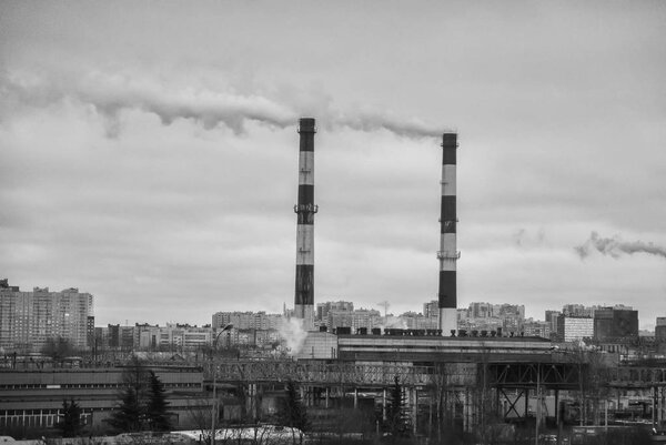 Factory in the city. Environmental pollution threat. Black and white.