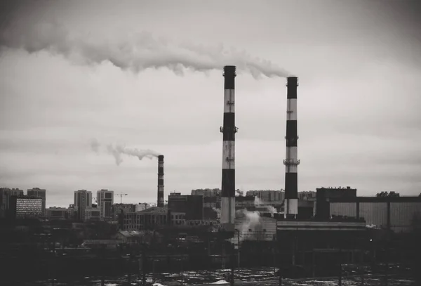 Factory in the city. Environmental pollution threat. Black and white. — Stock Photo, Image