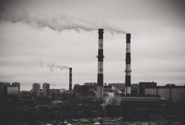 Factory in the city. Environmental pollution threat. Black and white.