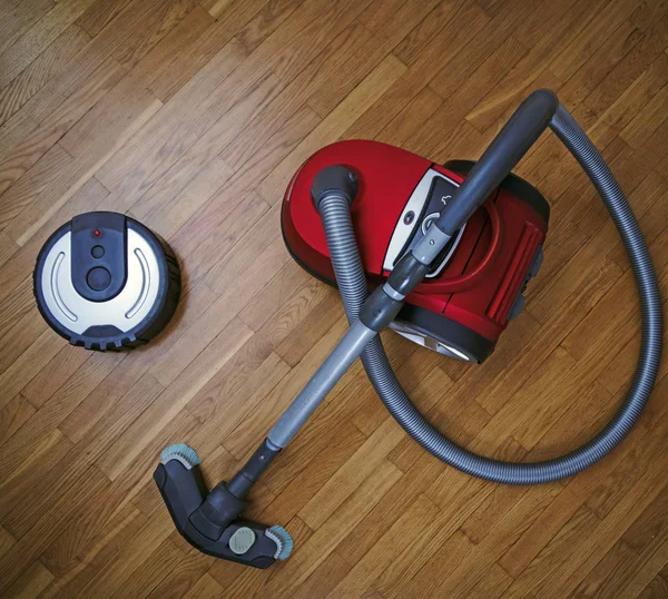 Robotic vacuum cleaner vs Vacuum cleaner. — Stock Photo, Image