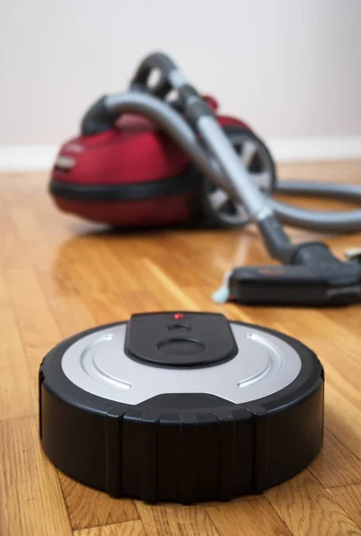 Robotic vacuum cleaner vs Vacuum cleaner. — Stock Photo, Image