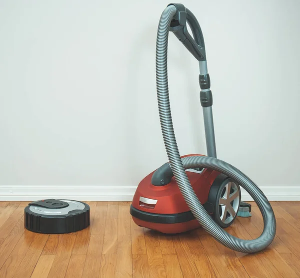 Robotic vacuum cleaner vs Vacuum cleaner. — Stock Photo, Image