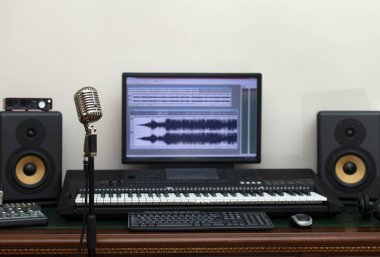 Ev kayıt stüdyosu profesyonel monitörler ve MIDI klavye ile.