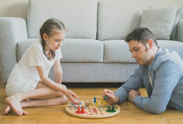 Little girl and her father playing ludo. — Stock Photo, Image