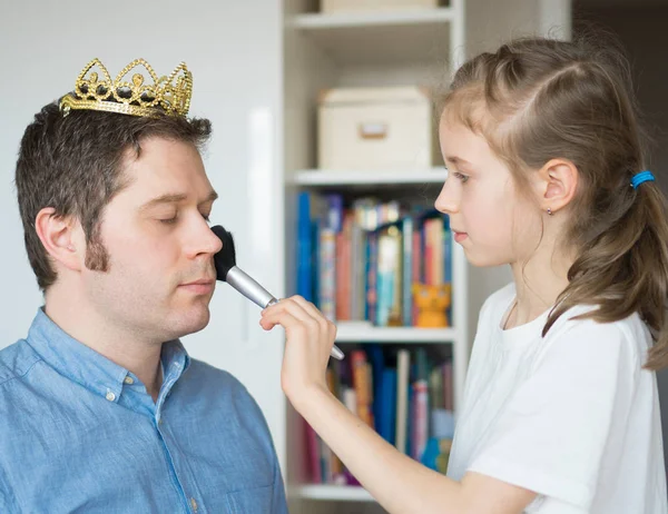 Menina bonito fazendo maquiagem para seu pai . — Fotografia de Stock