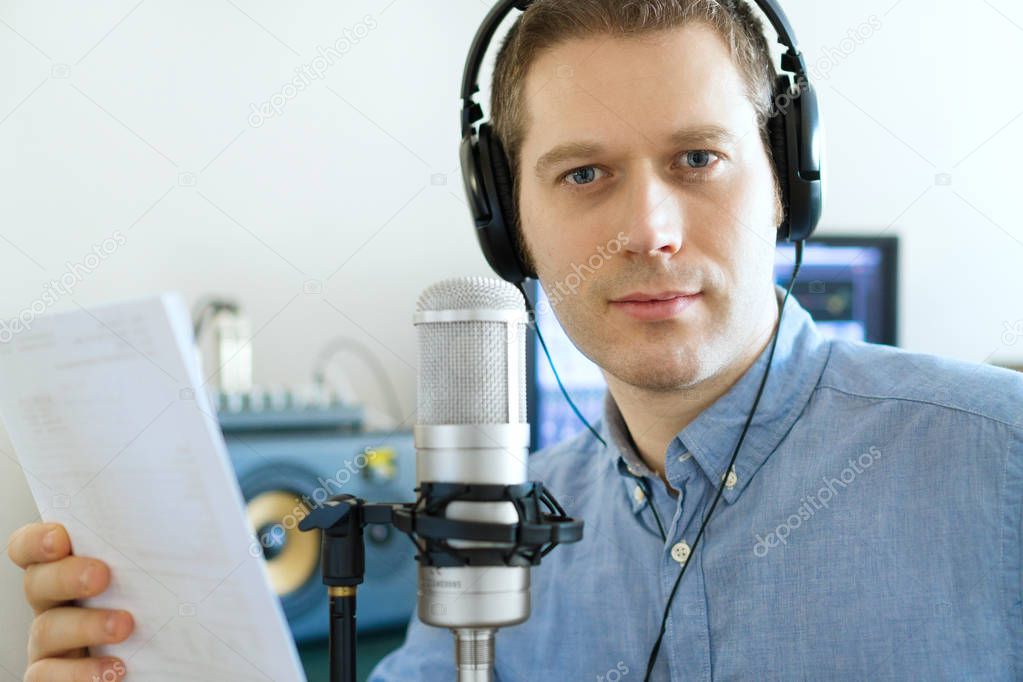 Handsome man recording an advertisement on the radio station.