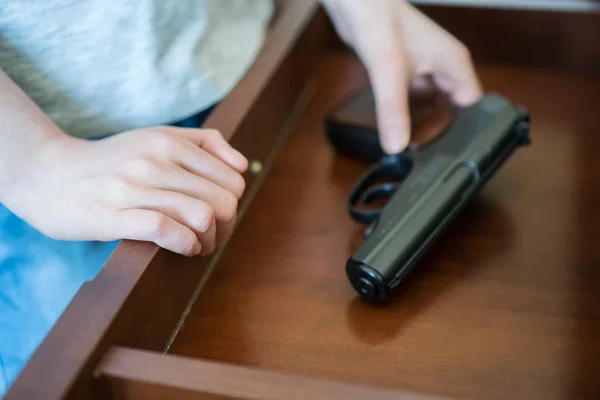 Ребенок нашел пистолет в ящике стола дома . — стоковое фото