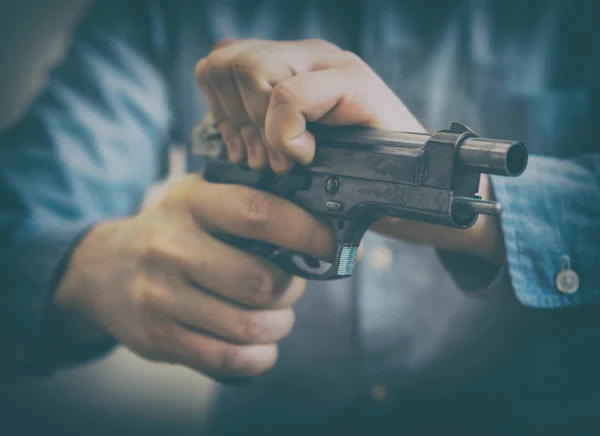 Mãos masculinas a recarregar arma. Vista de perto . — Fotografia de Stock