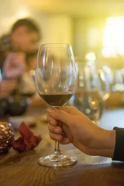 Woman holding glass of red wine. Party in the bar. — Stock Photo, Image