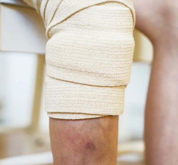 Dětské koleno s gázovým obvazem. Pohled zblízka. — Stock fotografie