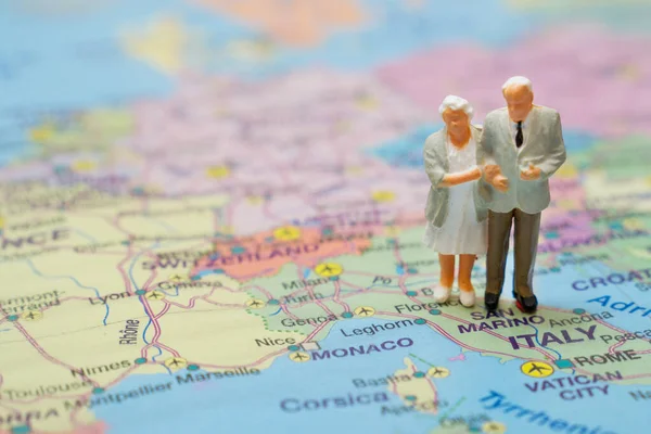 Figures of the elderly couple on a map of Italy.