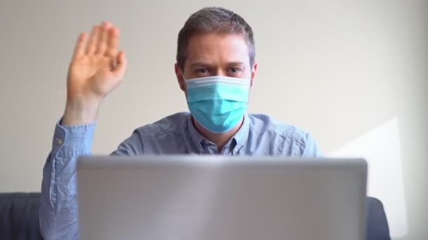 Man Medical Mask Welcomes Video Calling Indoors — Stock Video