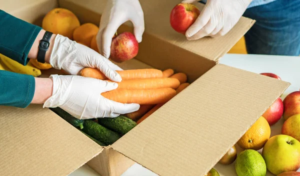 Volunteers Protective Medical Gloves Putting Fruits Vegetables Donation Box — Stock Photo, Image