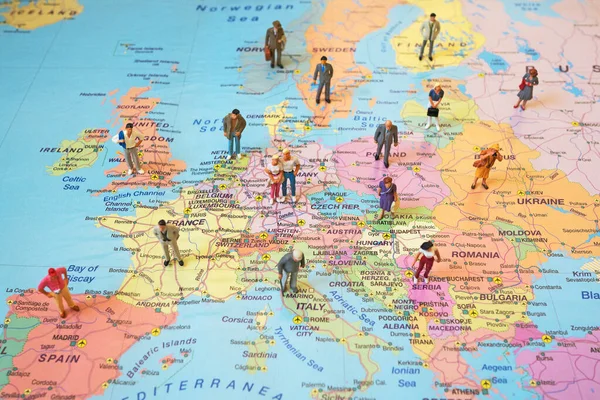 Many figures of people are placed on Europe map. Open borders concept.