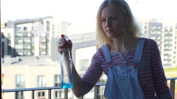 Young woman cleaning the window, slow motion — Stock Video