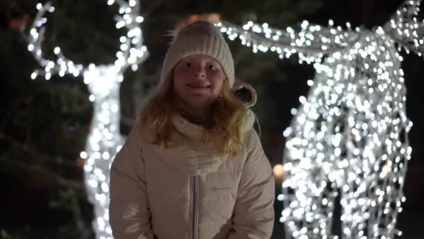 Beautiful slow motion video - a blonde girl throws snow at the camera — Stockvideo