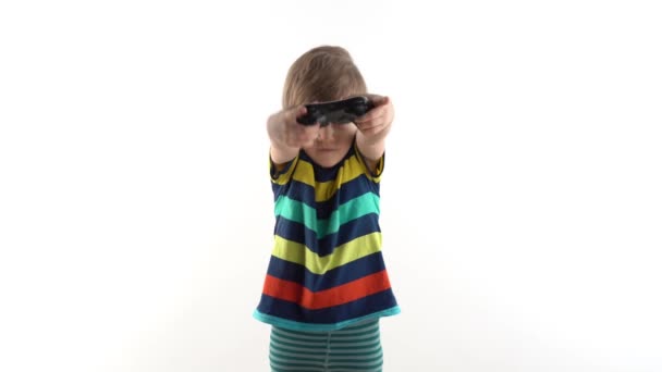 Little boy in the studio on a white background plays the joystick in video games — Stock Video