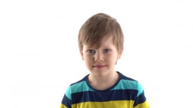 portrait of a little boy in the studio grimaces on a white background