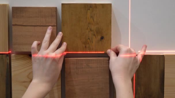 Original modern repair in a loft style. woman decorates a wall in an apartment with wooden pieces — Stock Footage Original modern repair in a loft style. woman decorates a wall in an apartment with wooden pieces Video Clip