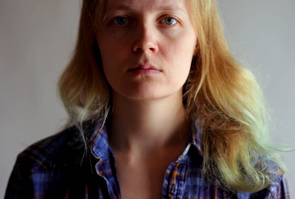 portrait of a simple serious woman without makeup