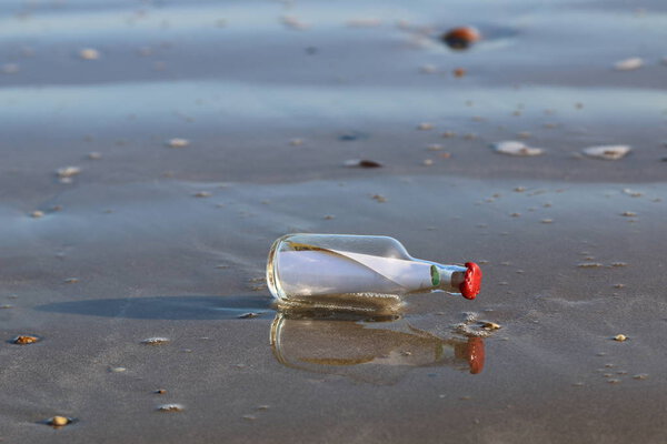 Message in bottle washed onto the sand