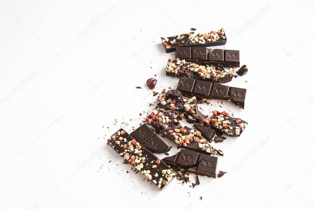Broken chocolate with nuts berries