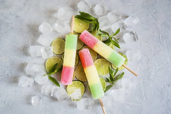 Multicolored ice cream, lime and ice.