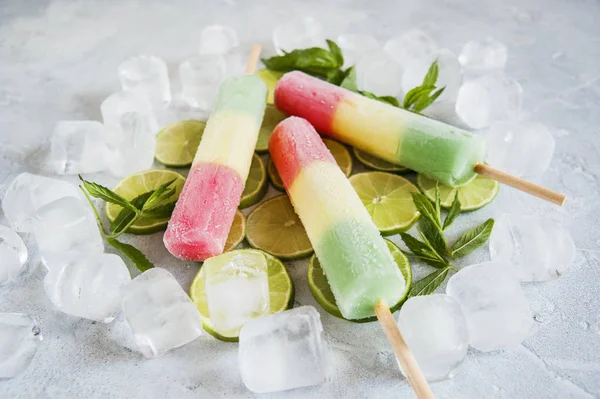 Multicolored ice cream, lime and ice.