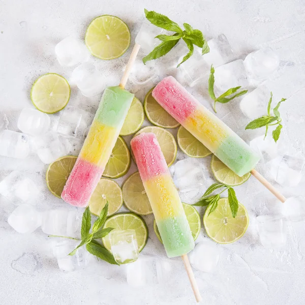 Multicolored ice cream, lime and ice.